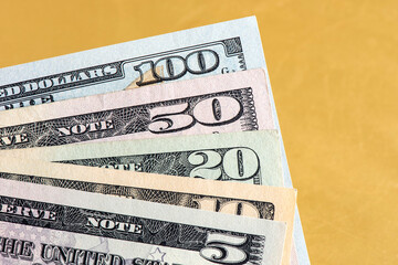 Many american dollar banknotes corner on the golden background. 