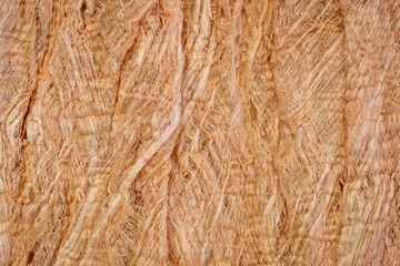 raw, natural mulberry paper handmade in Thailand - background and texture of fibers