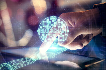 Double exposure of man's hands holding and using a phone and crypto currency blockchain theme drawing.