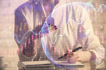 Double exposure of financial graph sketch hologram and woman holding and using a mobile device. Stock exchange concept.