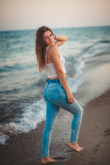 sexy young model by the sea on the beach
