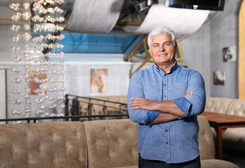 Senior male business owner in his restaurant