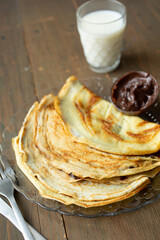 Chocolate pancakes on a wooden table