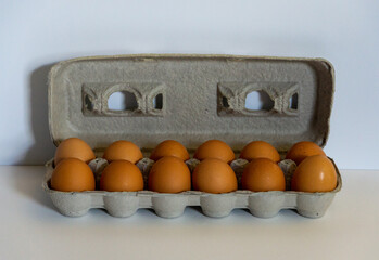 Dozen Large Brown Eggs in egg carton fresh on white background stock photograph