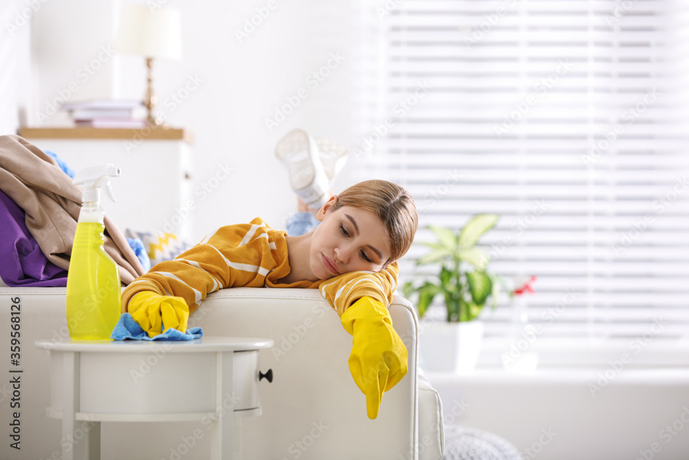 Sticker Lazy young woman wiping table at home. Cleaning and housework