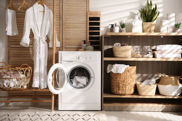 Modern washing machine and shelving unit in laundry room interior - obrazy, fototapety, plakaty