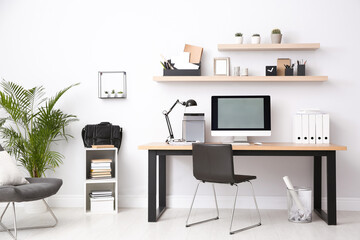 Modern computer on table in office interior. Stylish workplace