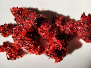 Ripe red saguaro fruit pulp with black seeds ready to eat