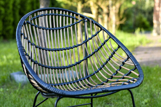 Close up of relaxing wicker chairs in the green garden. Close up. Selective focus. 