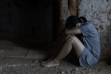 Human trafficking concept.Young girl sitting in old room.teenager girl victims of trafficking.