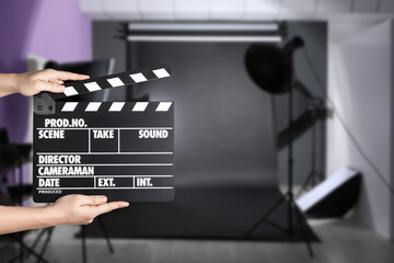 Assistant holding clapperboard on filming location, closeup. Cinema production