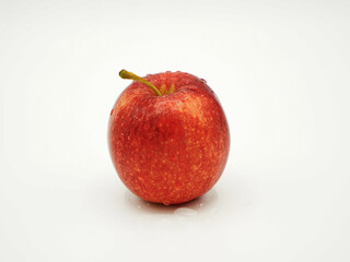A single red apple with water droplets.