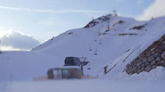 View of chairlift on top of Nordkette mountain with moving clouds in background