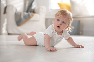 Cute little baby on floor at home