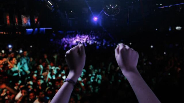 Woman Hands dancing at a Disco. Close-Up. 