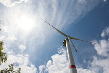 Modern wind turbine against cloudy sky, low angle view. Alternative energy source