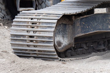 detail of a heavy steel caterpillar tread from a construction excavator