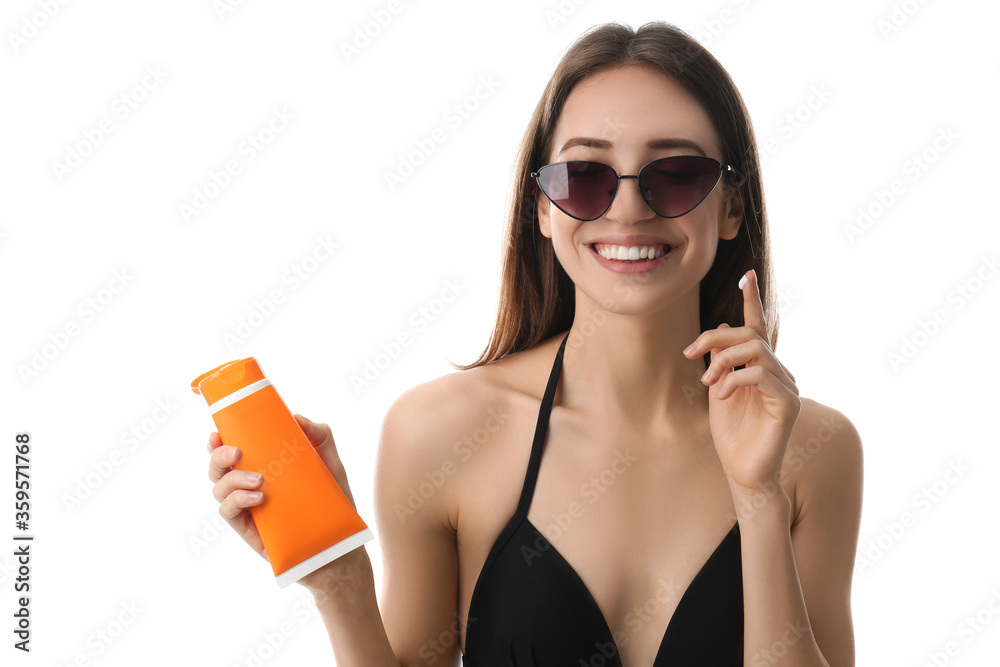 Poster Young woman applying sun protection cream on white background