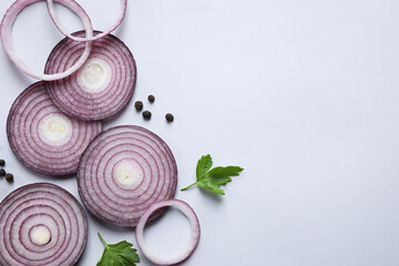 Flat lay composition with cut onion and spices on light background. Space for text