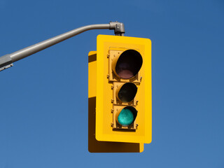 a traffic signal light with the green light lit