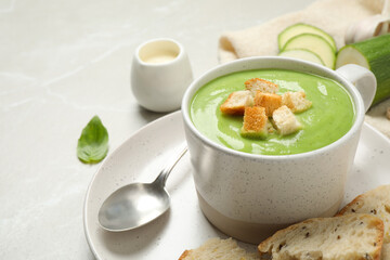 Tasty homemade zucchini cream soup served on light table
