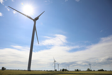 Field with wind turbines, low angle view. Alternative energy source