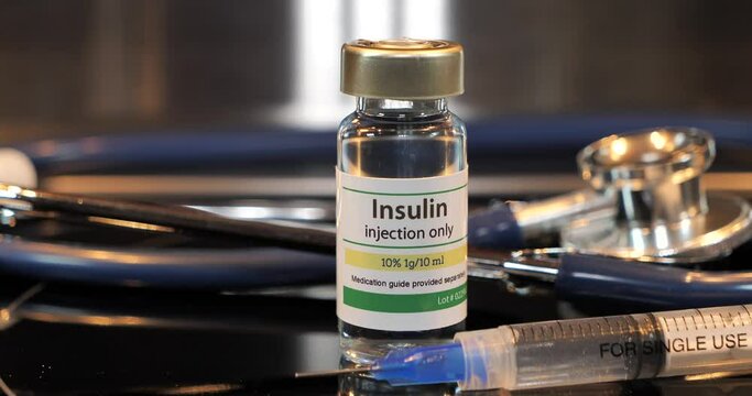 Vial of insulin injection with syringe and stethoscope