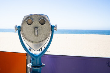 colorful viewfinder at beach with blue skies, sand, and colorful wall
