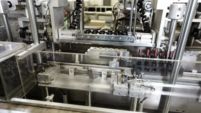 Manufacture lipstick in cosmetic factory. Cosmetic industry
