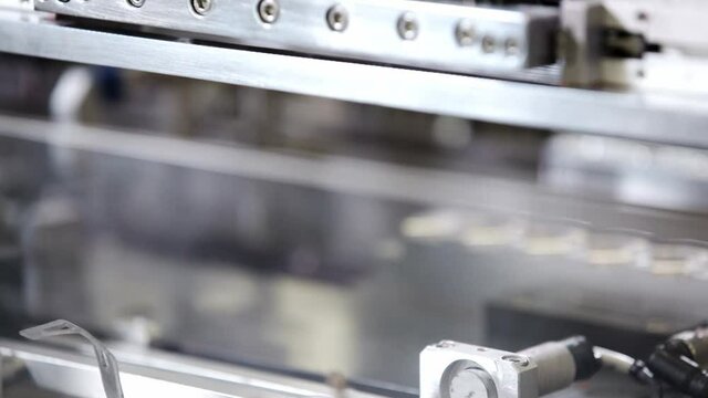 Lipstick on conveyor at cosmetic factory. Production lipstick in factory