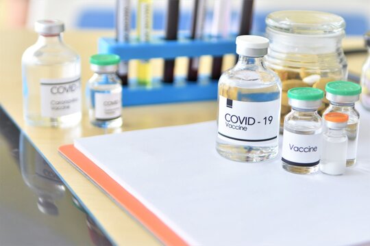 medicine bottles and syringe, vaccine to covid-19 concept