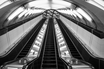 Times square subway escalator in black and white.