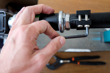 loosening the screw with a hex wrench. repair of household items at home