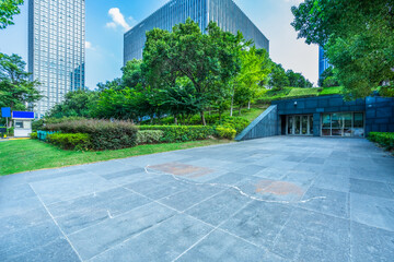 empty brick floor front of modern buildings.