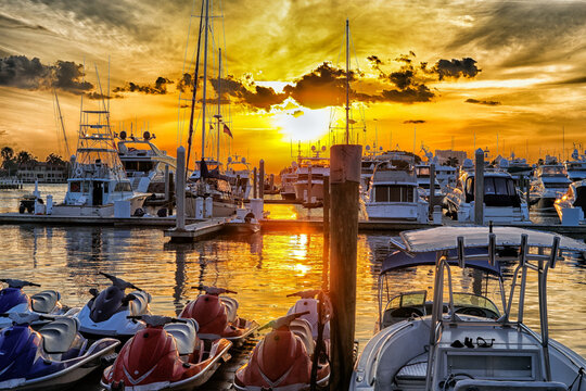 marina and dock with boats dramatic sunset