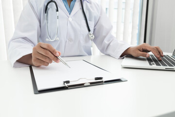 The doctor is examining and analyzing the treatment history of patient in the hospital.