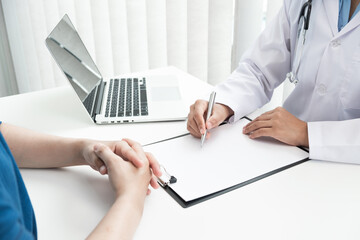 The doctor is consulting about treatment plan with patient in the hospital.
