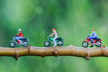 Miniature figures rider  motor cycle in tropical garden 