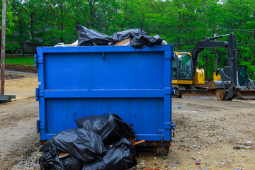 Truck loading a full recycling container trash dumpsters being full with garbage container trash