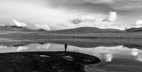 Morning at McDonald Lake in black and white with person silhouette