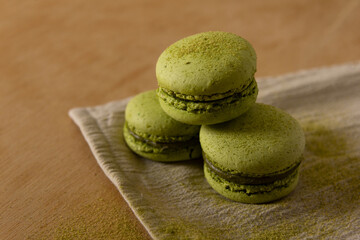 Green tea matcha macaron french dessert on wooden table close up