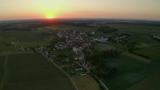 Aerial view, Moving shot, Scenic view of Town Hallertau, Holledau in Germany, Sunset and foggy sky in the background.