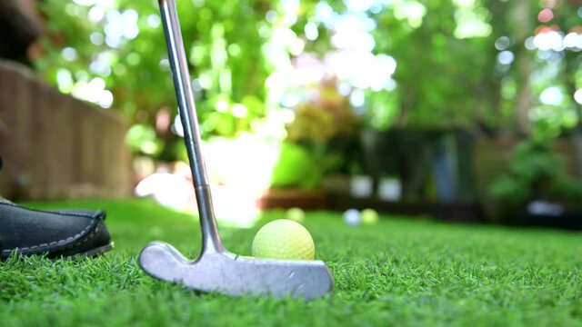 Play golf in the garden. Sport and workout during work home. Social distancing and wellness lifestyle.