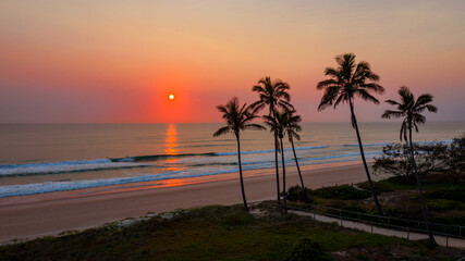 Fototapeta na wymiar Ocean sunrise with palm tree's by the beach, Main beach Gold Coast.