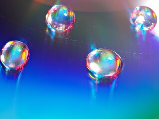 blurred water droplets with blue light on bright backgronud, dark and shiny , abstract background, macro image for card design