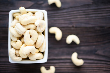 Full Raw Cashew Nuts in white ceramic bowl