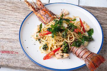 Spaghetti with spicy lobsters in white plate