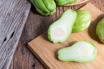 Fresh chayote fruits (Sechium edulis) on wood background