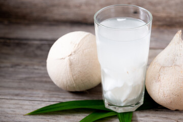 Fresh coconut juice in a glass with coconut white meat isolated on white