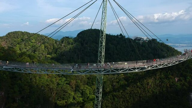 Drone flying towards Langkawi Sky Bridge with cable cars in the background on Langkawi Island in Malaysia.